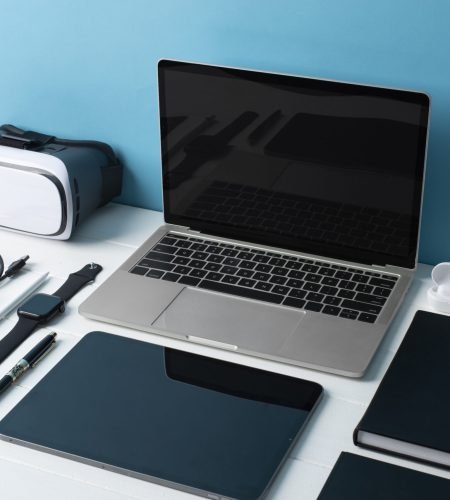 Modern workspace with laptop, tablet, and smartphone on desk